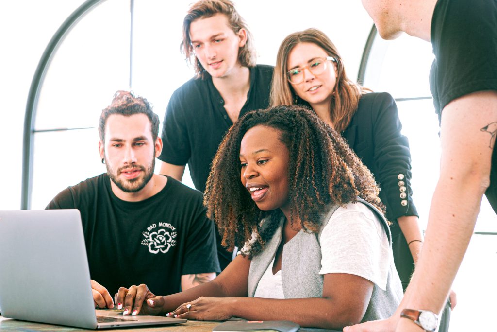 Accountants having a meeting while the accountant near the laptop is smiling