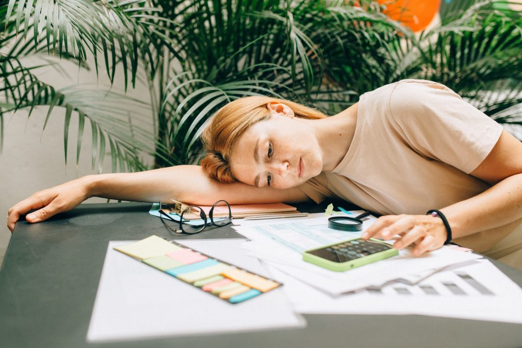 female business owner tired from doing her finances