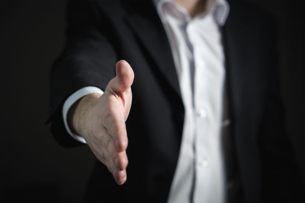 accountant initiating a handshake with his right hand