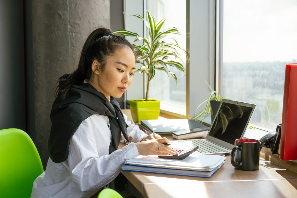 accountant calculating tax returns using calculator