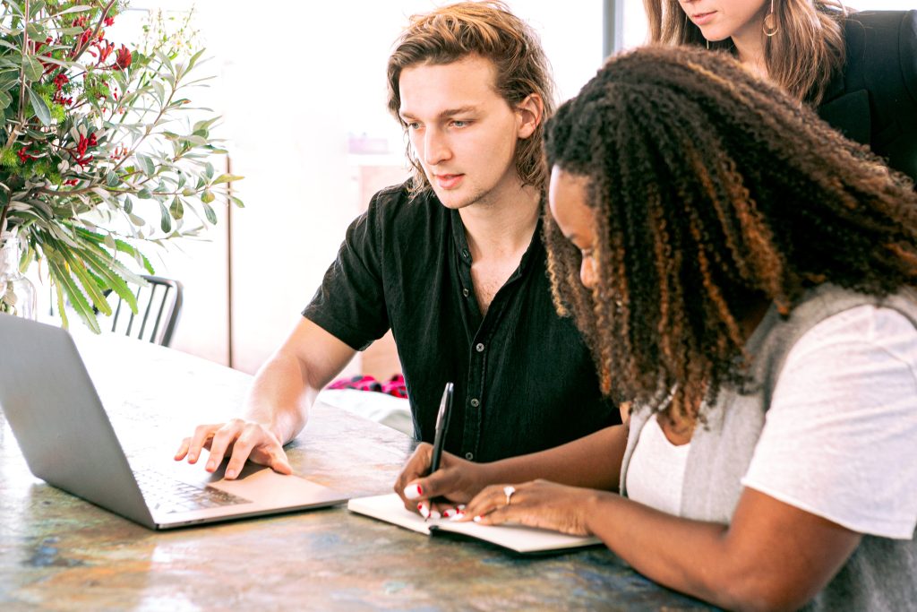 accountant explaning the report while the intern is taking notes