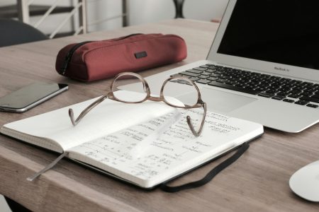 reading glasses on top of a notebook
