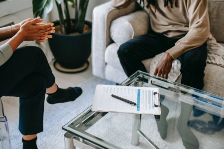 accountant meeting with his client while his notes is on the table