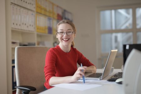 happy accountant smiling while infront of her laptop