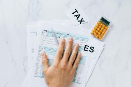 tax return paper beside an orange calculator